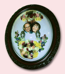 tribute florals preservation arranged around small urn with ashes and photo of couple