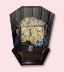 preserved bouquet of yellow roses standing upright in acrylic hexagon case