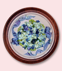 blue hydrangeas with blue ribbon preserved and encased in an oval frame