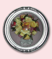 preservation of multi-colored bouquet in round silver frame encasement