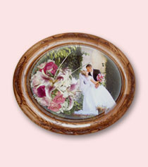 wooden frame encasement of star lily and photo of groom holding bride