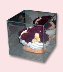 glass box with sculptured hands holding red and white preserved roses