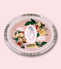 a drawing of Jesus surrounded by preserved tribute flowers in white frame