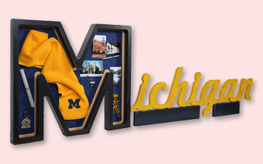 custom shadow box shaped as letters of university with school memorabilia