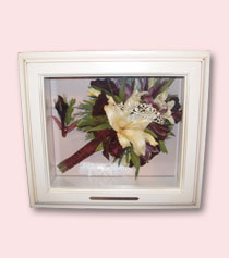 wedding bouquet with white lily and feathers preserved in white rustic shadow box