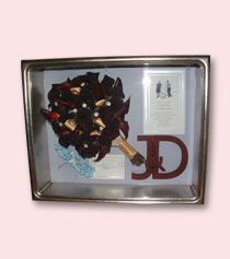 red roses bridal bouquet preserved in silver shadow box with other wedding memorabilia