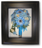 blue daisies wedding bouquet wrapped with blue ribbon and matching blue boutonniere preserved in brown wood shadow box