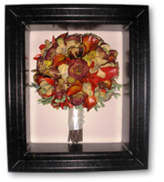 brown wood shadow box with orange roses bridal bouquet preservation and stems wrapped in cream ribbon with perls