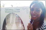 smiling woman holding wedding gown preservation box