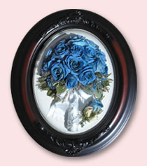 blue roses bouquet and boutonniere preserved in oval dark walnut frame