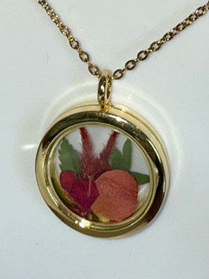 preserved flower in gold necklace